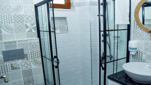 ein Badezimmer mit Glasdusche und Waschbecken in der Unterkunft Gökçeada Deep Breath in Canakkale + 65 Fotos