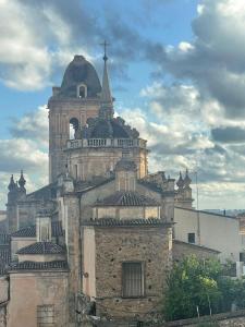 um edifício antigo com uma torre em cima em Estudio TAU em Jerez de los Caballeros