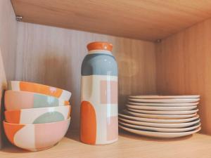 a vase sitting on top of a shelf with plates at Aparthotel AMMI Nice Lafayette in Nice