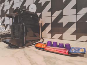 a toaster sitting on top of a counter next to sidx sidx at Aparthotel AMMI Nice Lafayette in Nice