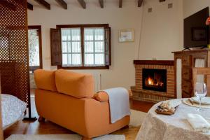 a living room with a couch and a fireplace at El Molino de Bonaco in San Vicente de la Barquera