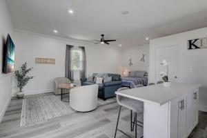 a white living room with a couch and a table at Guest House In a Downtown Bonita Springs Compound in Bonita Springs