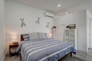 a bedroom with a bed with a blue and white striped blanket at Guest House In a Downtown Bonita Springs Compound in Bonita Springs