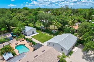 an aerial view of a house with a pool and trees at Guest House In a Downtown Bonita Springs Compound in Bonita Springs