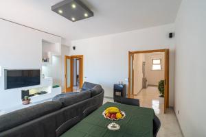 a living room with a couch and a table at Belvedere dell Etna - Ampio Appartamento con vista Mare e Taormina in Giarre
