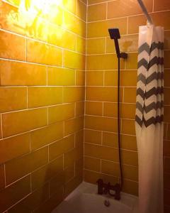 a yellow tiled bathroom with a shower with a hose at Chester/Hoole Contemporary Home. Sleeps 6 +Netflix in Chester