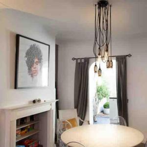 a dining room with a table and a chandelier at Chester/Hoole Contemporary Home. Sleeps 6 +Netflix in Chester