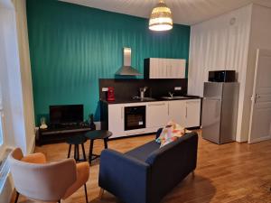 a living room with a couch and a kitchen at LE 1 " GÎTES TOUT CONFORT à COLMAR CENTRE" in Colmar
