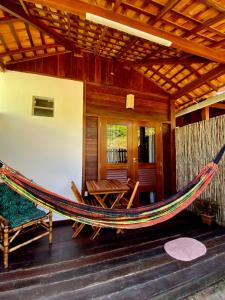 a hammock on the porch of a house at Chalés Paradise in Atins