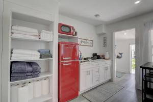 a red refrigerator in a kitchen with white cabinets at Three Rental Units In This Bonita Springs Compound in Bonita Springs