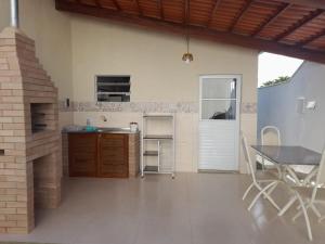 a kitchen with a table and a dining room at CASA CHAPADA SUL in Rio de Contas