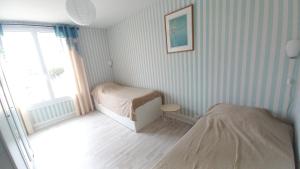 Posteľ alebo postele v izbe v ubytovaní LES FLOTS BLEUS - Appartement 2 chambres vue mer