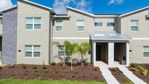 a rendering of a house with palm trees in the front yard at WonderFull 4Bd with Pool at Champions Gate 1174 in Kissimmee