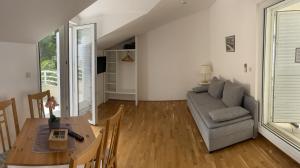 a living room with a couch and a table at Villa Viden Apartments in Tučepi