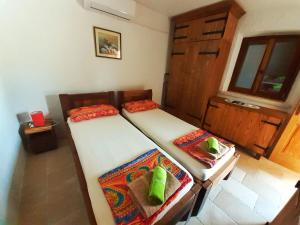 twee eenpersoonsbedden in een kamer met een raam bij Villa Viva Brac - Pool - Meerblick in Povlja +15 foto's