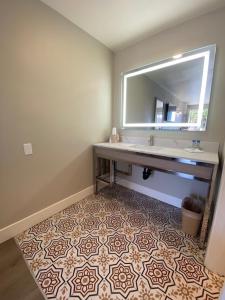 a bathroom with a sink and a mirror at Super 8 by Wyndham Oceanside Downtown in Oceanside