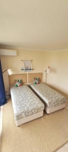 two beds sitting in a room with at T2+1 - Sousa Vila - Apartament with the best pool @ Algarve in Alvor