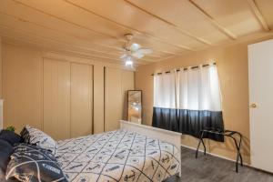 a bedroom with a bed and a ceiling fan at Nature Lover's Paradise. in Zephyrhills