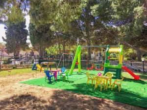 a playground with colorful play equipment in a park at Villa Panoramica sul Mare in Valderice