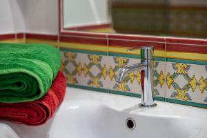 a towel sitting on a sink next to a faucet at Amalfi Residence in Conca dei Marini +52 photos