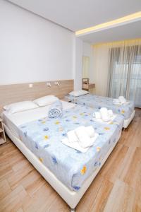 Postel nebo postele na pokoji v ubytování Hotel Zefyros