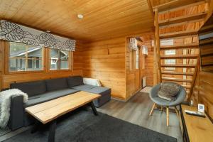 a living room with a couch and a chair at Villa Särkkä in Kalajoki