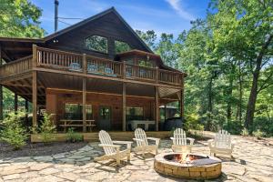 a log home with a fire pit and chairs at Bear Naked Bungalow in Blue Ridge