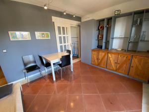 uma cozinha com mesa e cadeiras num quarto em Alcaudón 1 dormitorio by SIT ISLA CANELA na Isla Canela