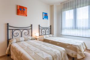 Posteľ alebo postele v izbe v ubytovaní Apartamento Narcis + 12 fotografií