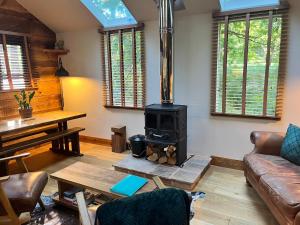 a living room with a wood stove in it at Keepers Cabin - Hot tub in Kings Lynn