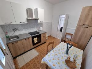 a kitchen with a table and a kitchen with a dining room at Retreat Apartments with free parking in Pula