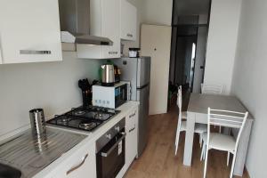 a kitchen with a stove top oven next to a table at Terrazza Silvio beautiful Lake view in Domaso