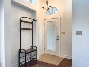 a hallway with a staircase and a door with a chandelier at Perdido-Orange Beach, Golfing 2BR-2,5BT in Pensacola