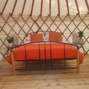 a bed in a yurt with two pillows at The Lawn Yurt in Tullow