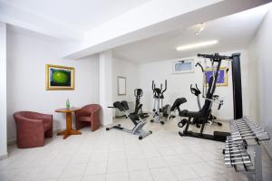 a gym with treadmills and exercise bikes in a room at Villa Kruna Grada in Trogir