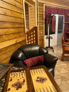 a leather chair and a leather couch in a room at Grigoleti River Club in Maltakva