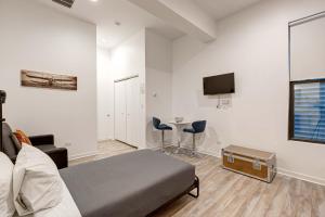 a bedroom with a bed and a table and a tv at Cabin 105 by 747 Lofts in Chicago