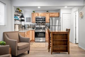a kitchen with stainless steel appliances and wooden cabinets at 11 Chelsea Place condo in Phoenix