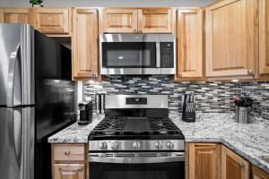 a kitchen with a stove and a microwave at 23 Chelsea Place condo in Phoenix