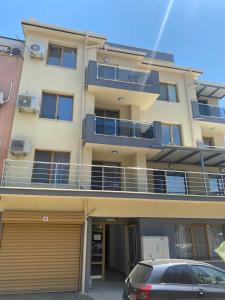 an apartment building with a car parked in front of it at Apartment Veronika in Sozopol