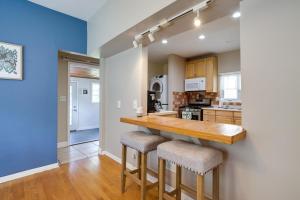 a kitchen with a wooden counter and stools at Pet-Friendly Saint Paul Home - Near Allianz Field! in Saint Paul
