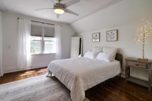 a white bedroom with a bed and a window at Pet-Friendly Saint Paul Home - Near Allianz Field! in Saint Paul