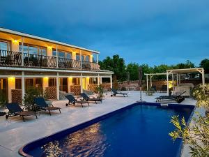 a swimming pool in front of a building at Vamyami Vama Veche in Vama Veche
