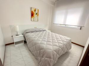 a white bedroom with a bed and a window at Park Raxo in Raxó +72 photos