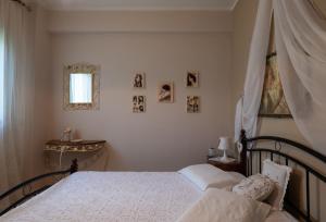 a bedroom with a bed and a window at Antique Apartment in Afitos