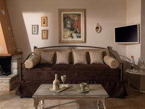 a living room with a brown couch and a table at Antique Apartment in Afitos