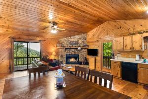 a kitchen and living room of a cabin with a fireplace at A Heavenly View in Blue Ridge