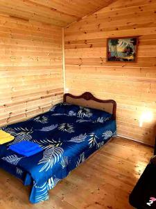 a bedroom with a bed in a log cabin at Eco Aura (RestZone) in Areguni