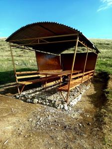 a wooden structure sitting on top of a field at Eco Aura (RestZone) in Areguni +6 photos