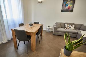 a living room with a wooden table and a couch at MONZA-MILANO - Comfort tra centro e stazione - WIFI in Monza